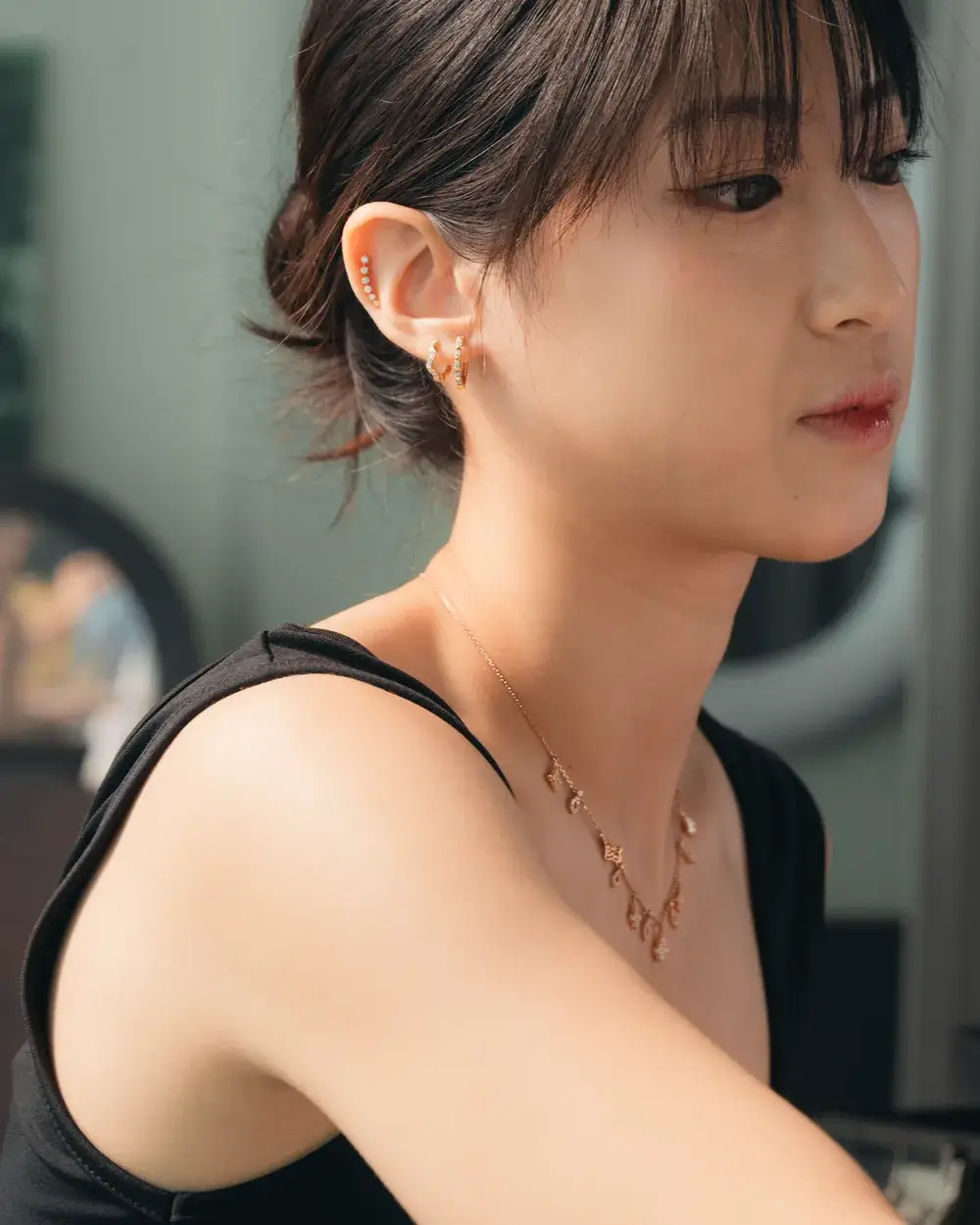 Profile view of a curated diamond ear stack