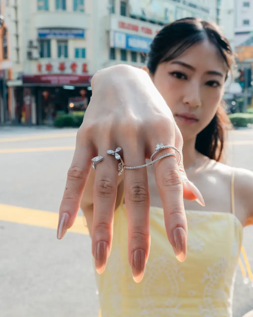 Slim diamond rings stacked across two fingers